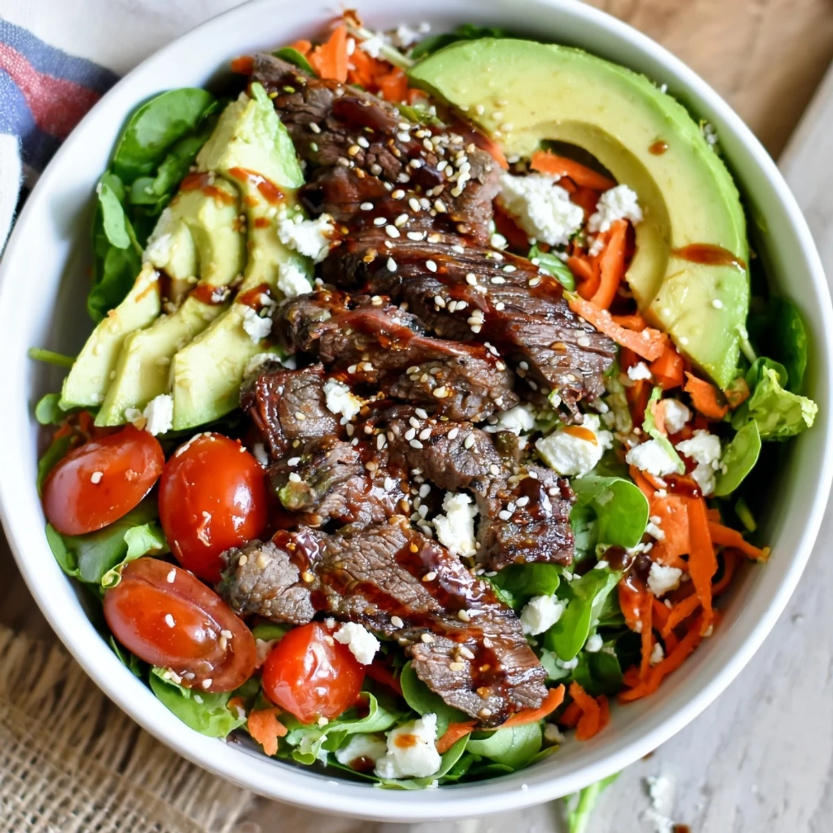 Beef Salad Bowl with juicy steak, cherry tomatoes, and feta, ready to serve on a marble counter.