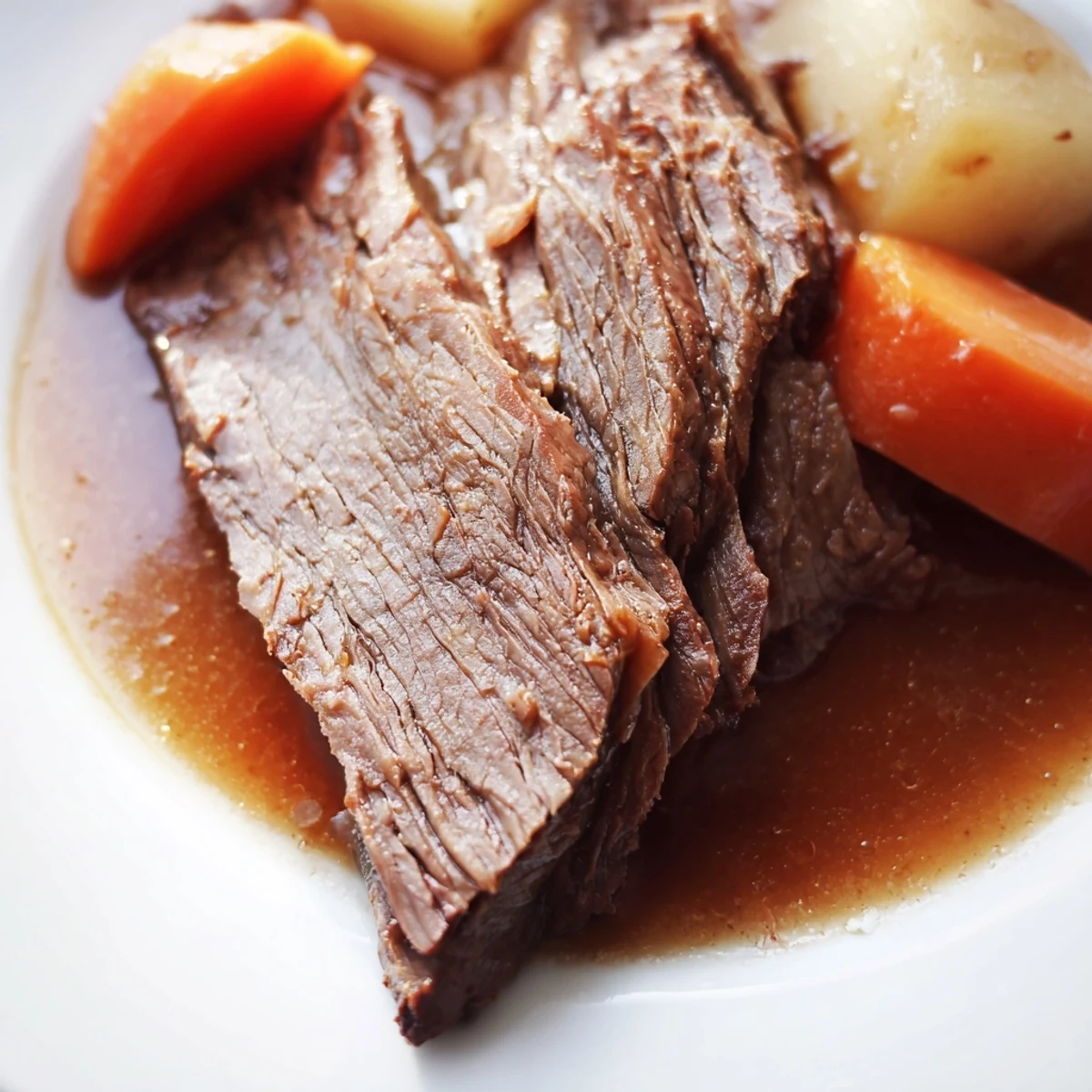 Sliced Slow Cooker Beef Roast and vegetables ready to serve, ideal for a family-style dinner.