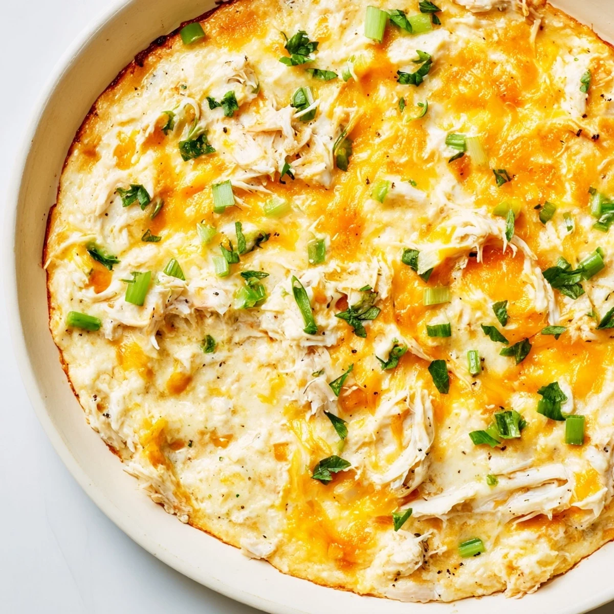 Spoonful of creamy Cajun Crab Dip with Crackers over a buttery cracker, highlighting the tender crab and spicy aromatics.