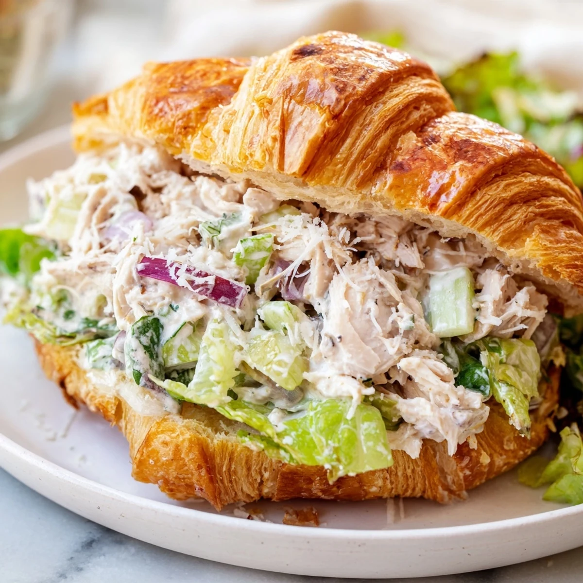 Buttery croissant sandwich piled high with Parmesan chicken salad and fresh chopped lettuce