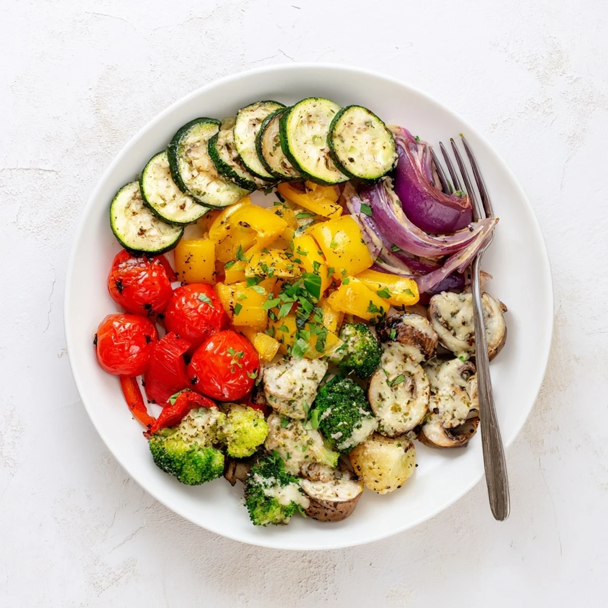 Golden zucchini bell peppers and eggplant drizzled with rich Parmesan cream sauce after roasting