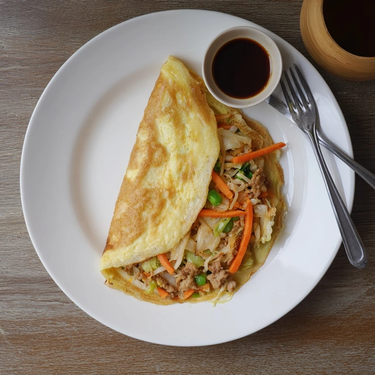 Golden Chinese style savory stuffed breakfast pancakes filled with seasoned meat and vegetables on a white plate