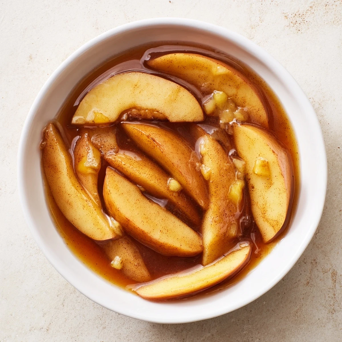 Golden tender Instant Pot cinnamon apples garnished with a pat of melting butter