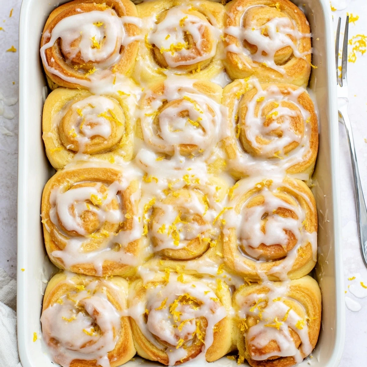Soft fluffy lemon rolls fresh from oven with sweet citrus sugar swirl filling