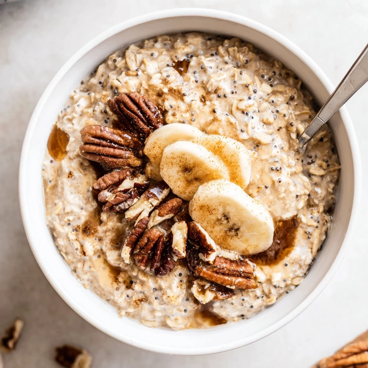 Brown Sugar Coffee Overnight Oats topped with sliced banana and toasted pecans