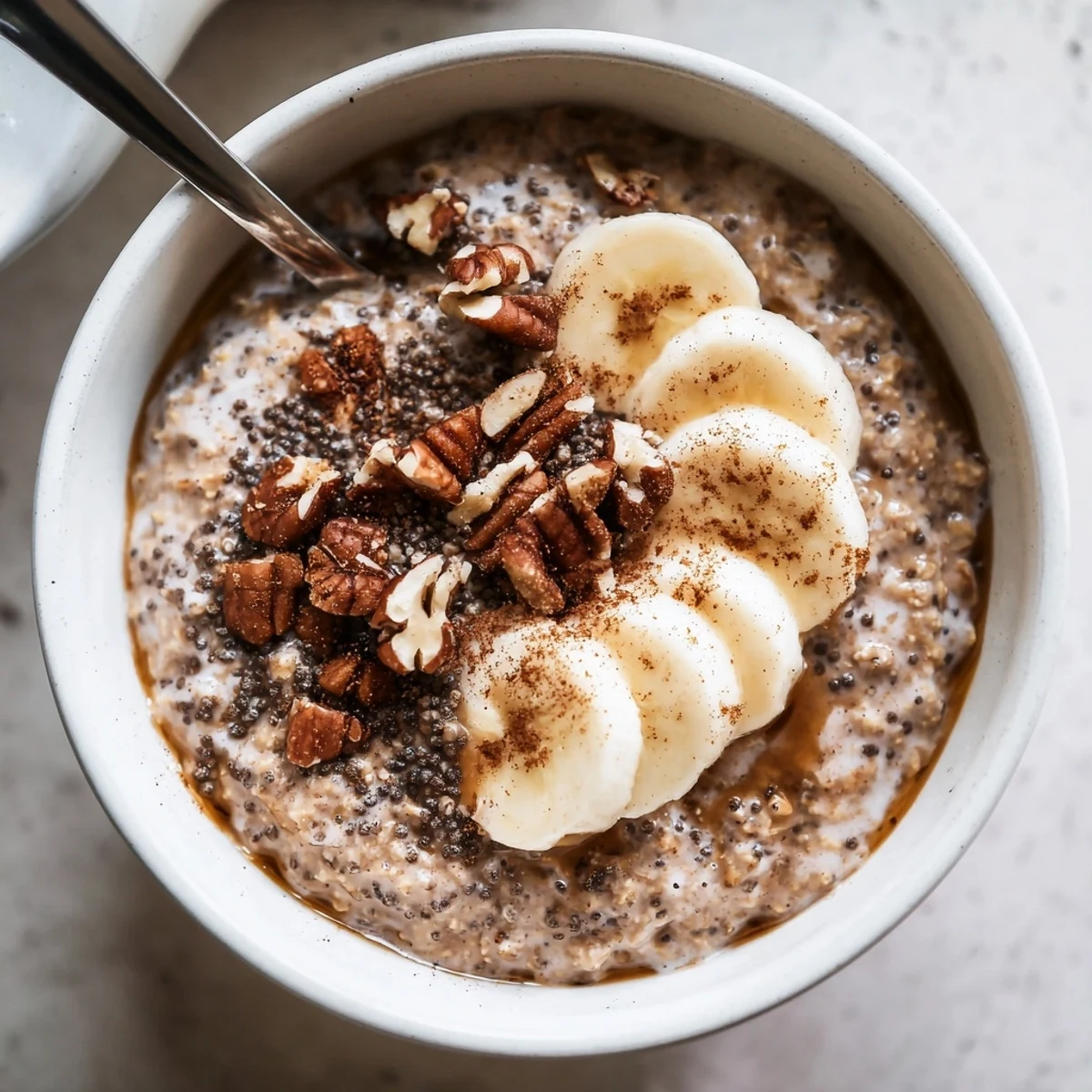 Mason jar of Brown Sugar Coffee Overnight Oats with maple drizzle and chia