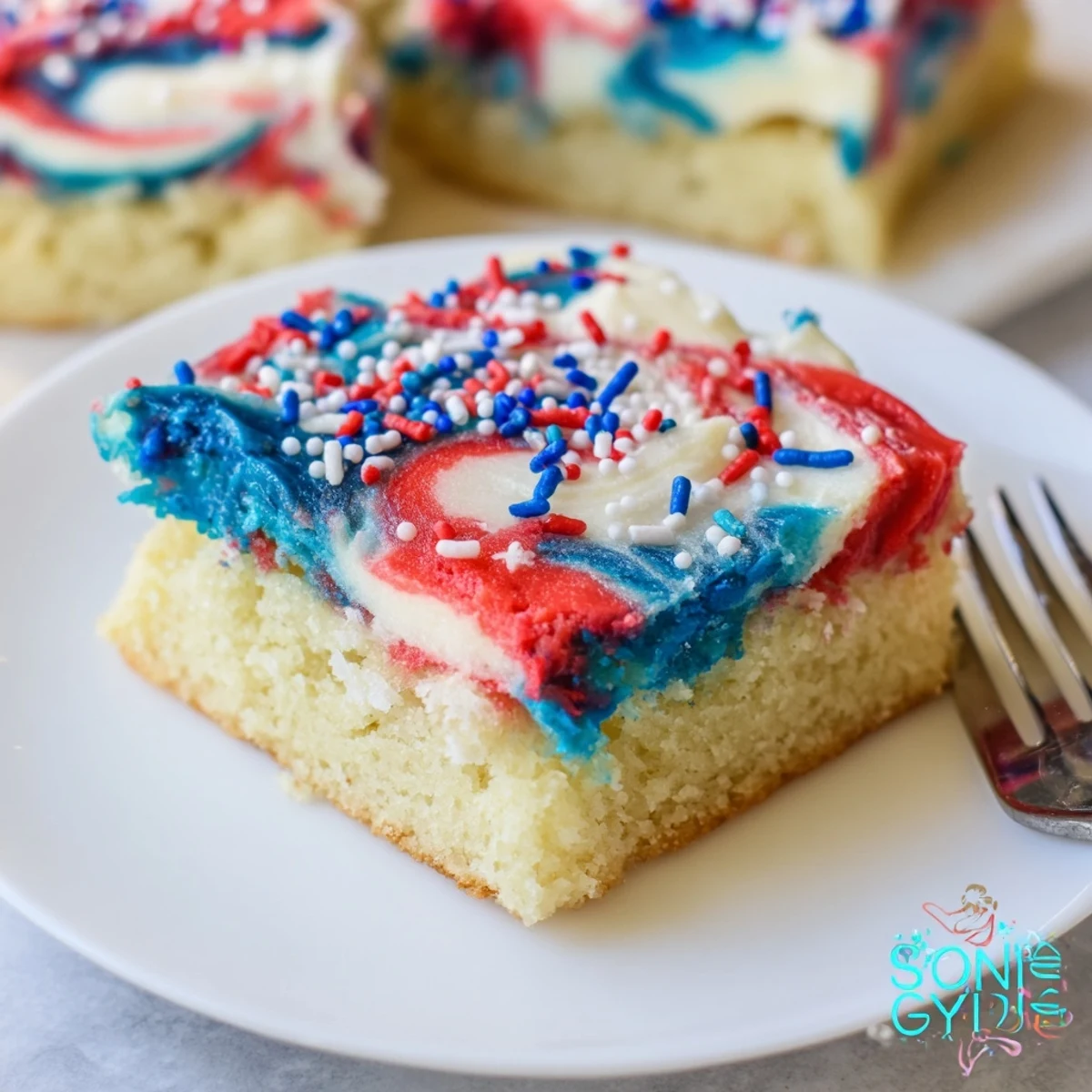 Patriotic Sugar Cookie Bars with swirled red, white, and blue frosting.