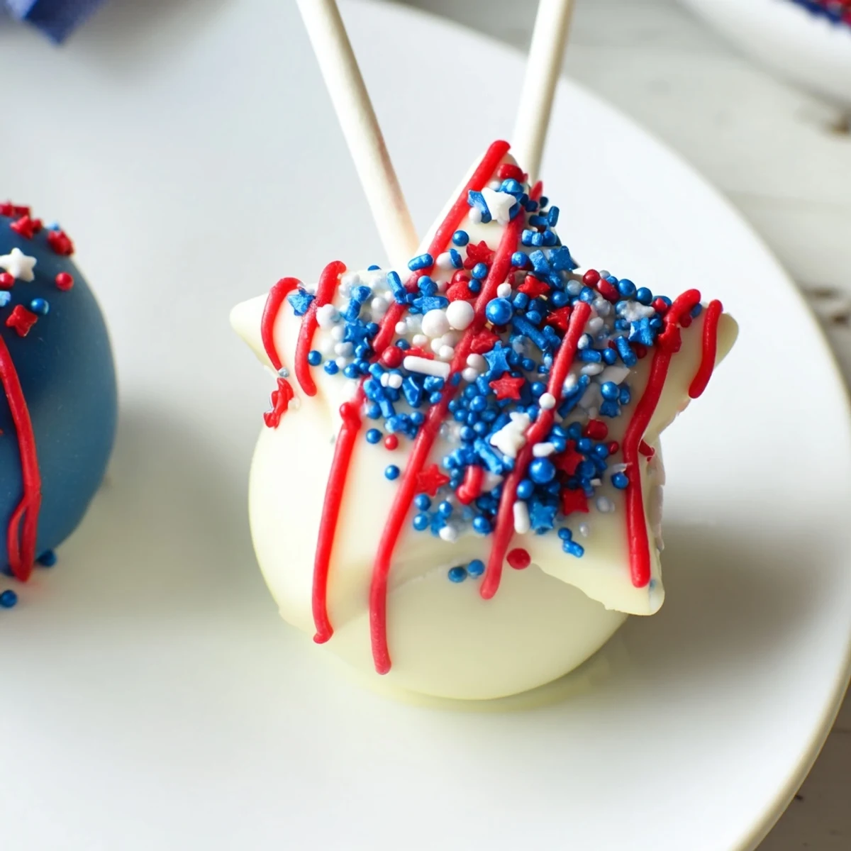 Chilled Fourth Of July Star Cheesecake Pops on sticks, tangy cream cheese center