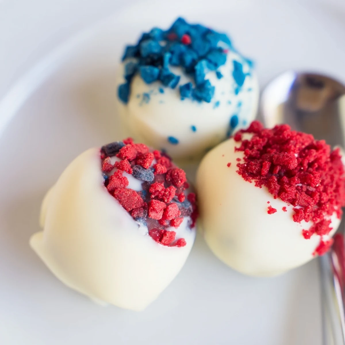 Of July Truffles Creamy And Patriotic on a chilled platter, berry-scented bites