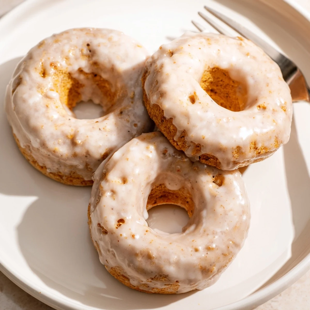 Warm Banana Donuts on a wire rack, golden, soft crumb, vanilla glaze
