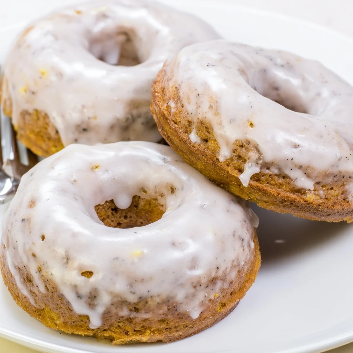 Glazed Banana Donuts stacked on plate, soft cake-like inside, light sweetness