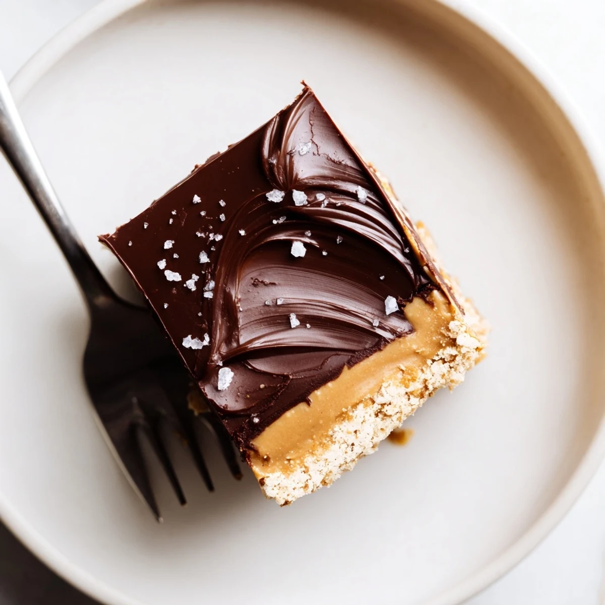 Tray of No Bake Peanut Butter Bars cut into squares, sprinkled with sea salt.