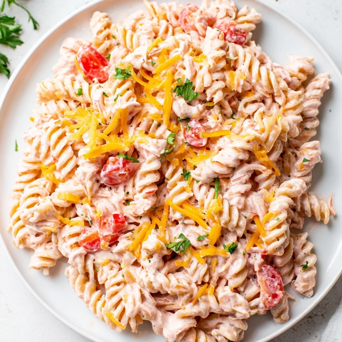 Colorful Pink Cadillac Pasta Salad with cherry tomatoes and red peppers in creamy pink dressing