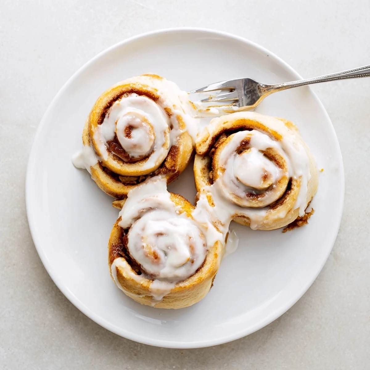 Golden Banana Bread Cinnamon Rolls in baking dish, ready for brunch