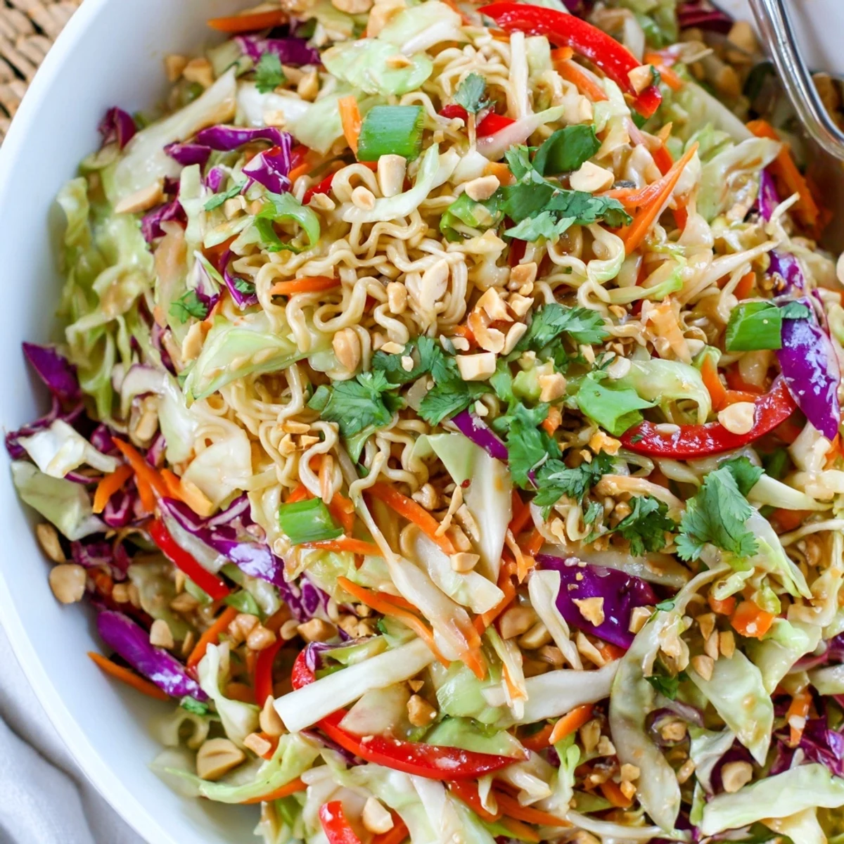 Serve chilled Asian Cabbage Salad topped with crushed peanuts and lime