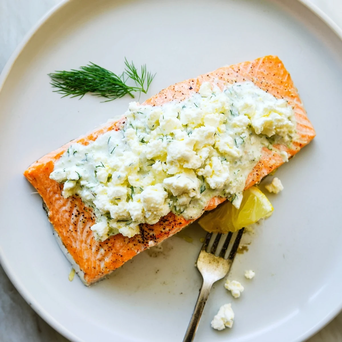 Salmon With Feta Dill Sauce over roasted potatoes, bright lemon and herbs
