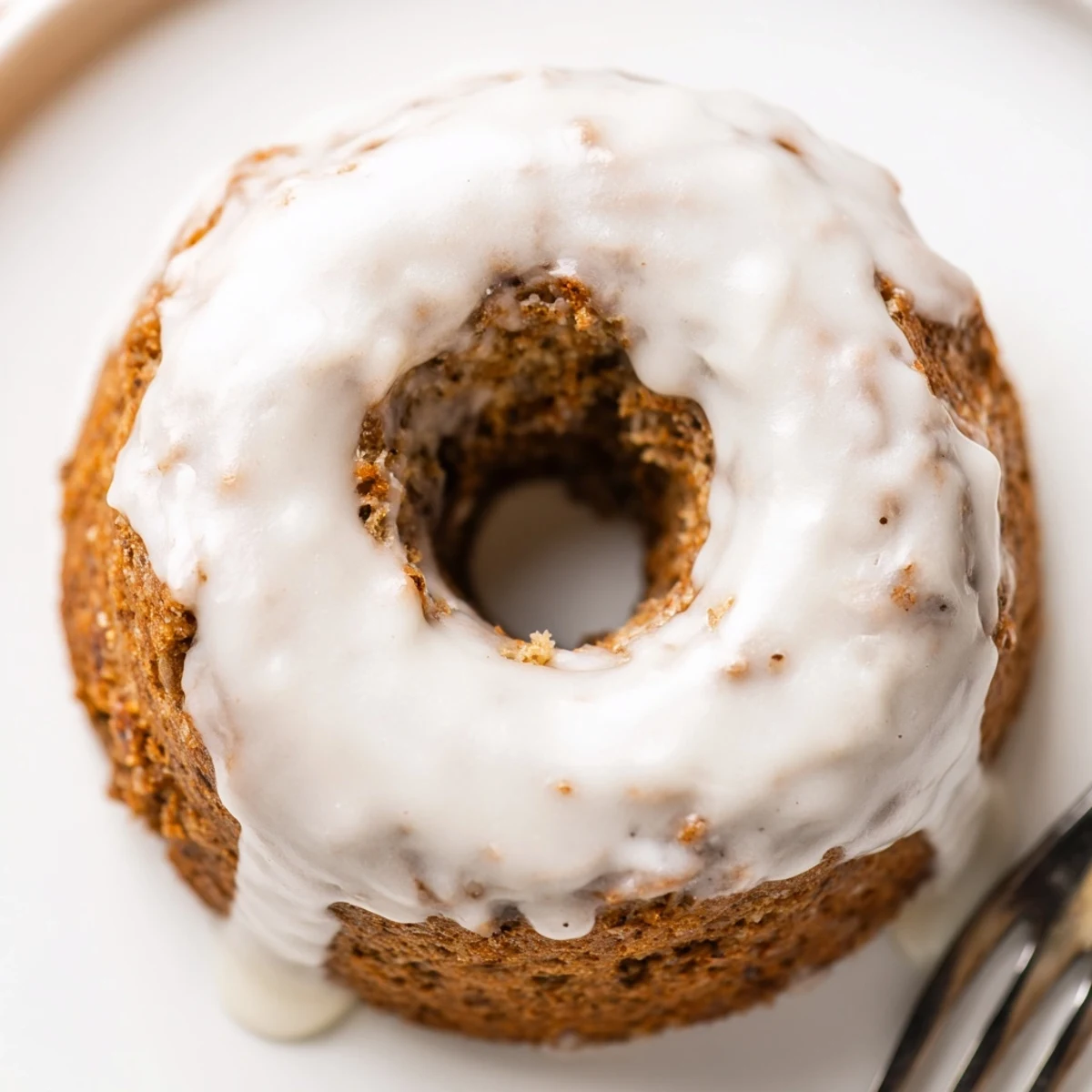 Freshly glazed banana bread donuts sprinkled with powdered sugar ready for breakfast