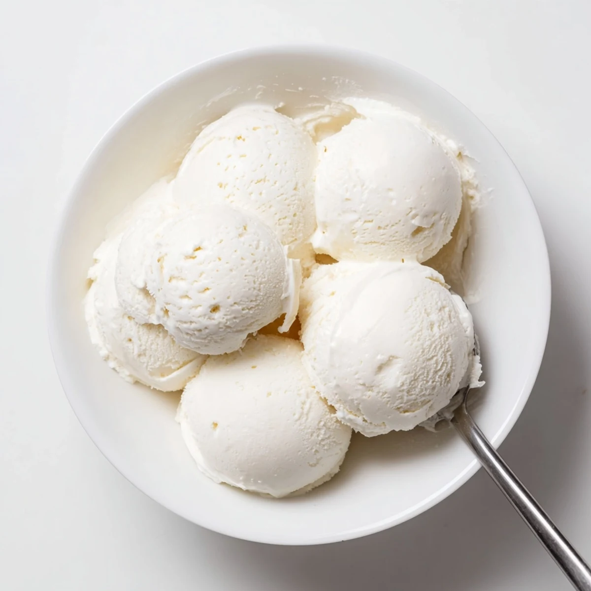 Smooth and velvety homemade ice cream recipe garnished with mint leaf and chocolate drizzle