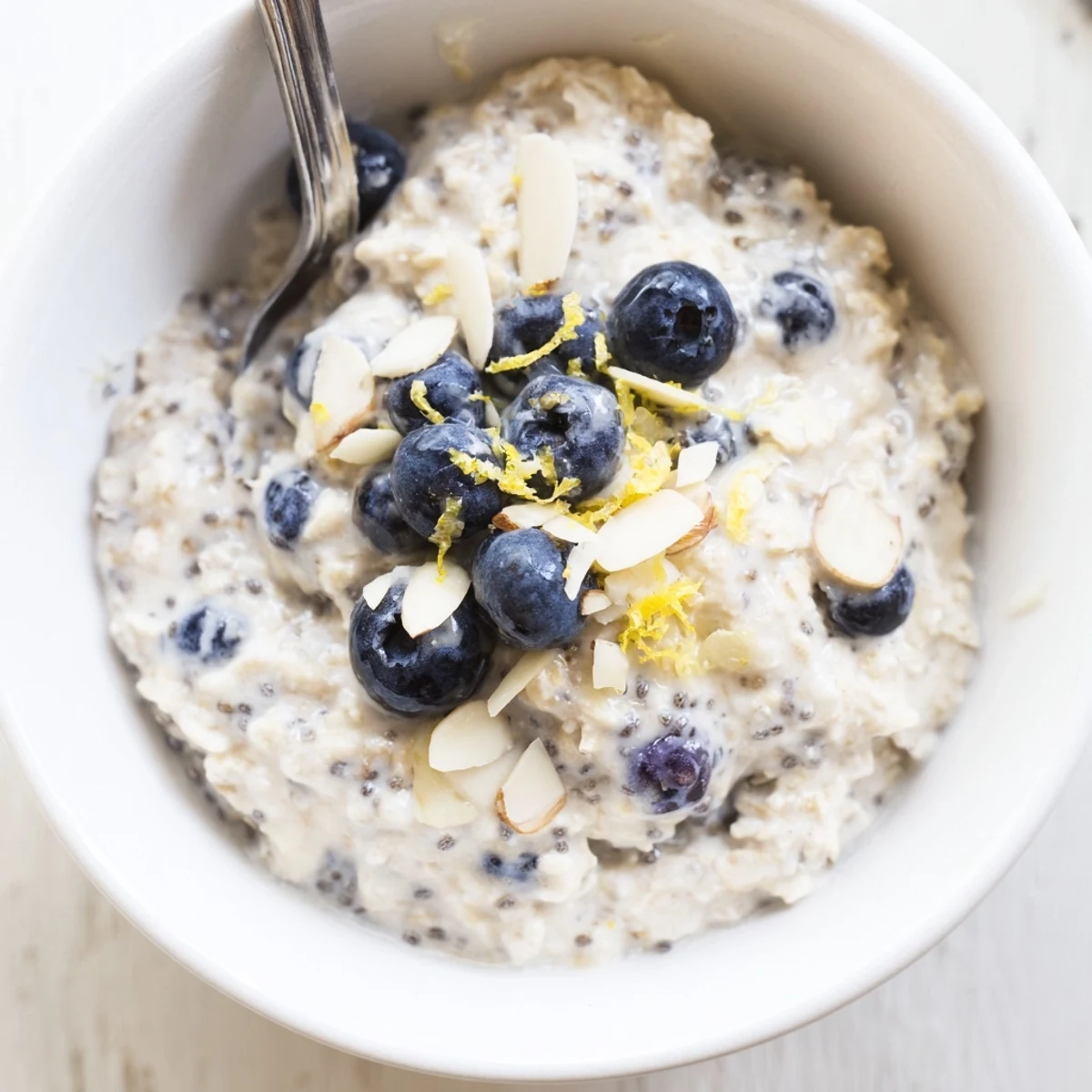 Creamy Blueberry Lemon Overnight Oats topped with fresh berries and lemon zest.