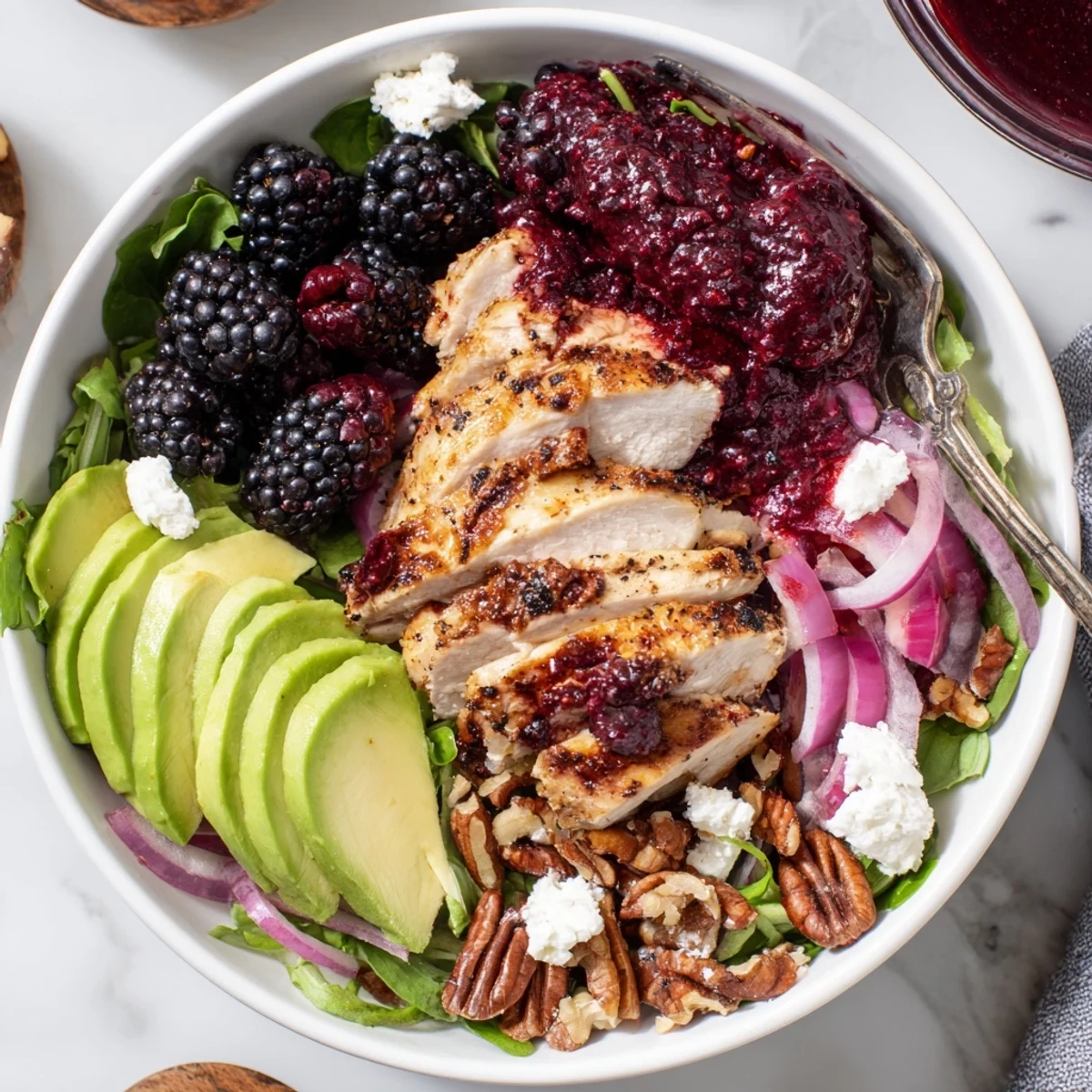 Bright Sweet Tangy Blackberry Chicken Salad Recipe on arugula, sliced avocado, balsamic drizzle.