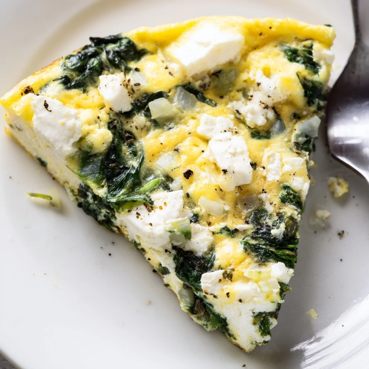 In a skillet, Spinach Frittata With Feta reveals soft eggs and oven-browned edges