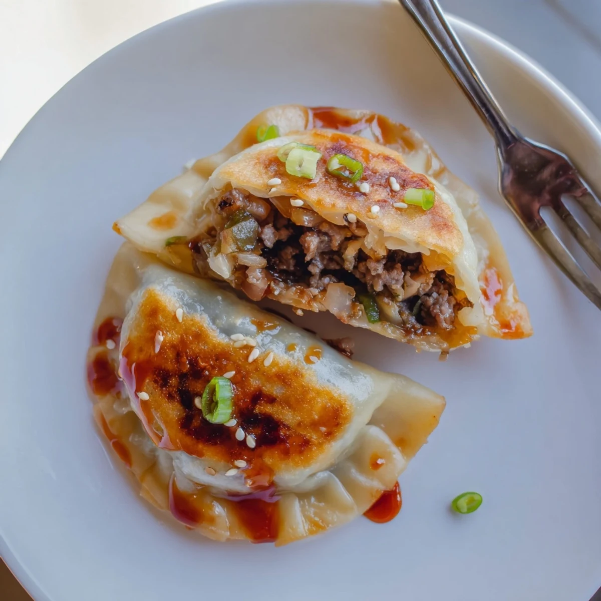 Savory Beef Mandu With Sweet Gochujang Glaze, golden crisp edges and sesame