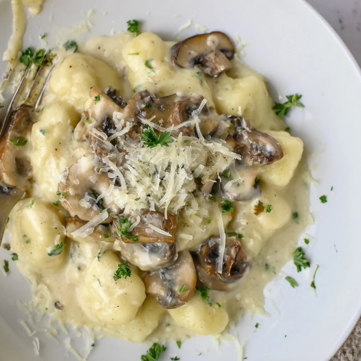 Mushroom Gnocchi In Cream Sauce: pillowy gnocchi, sautéed mushrooms, silky Parmesan cream.