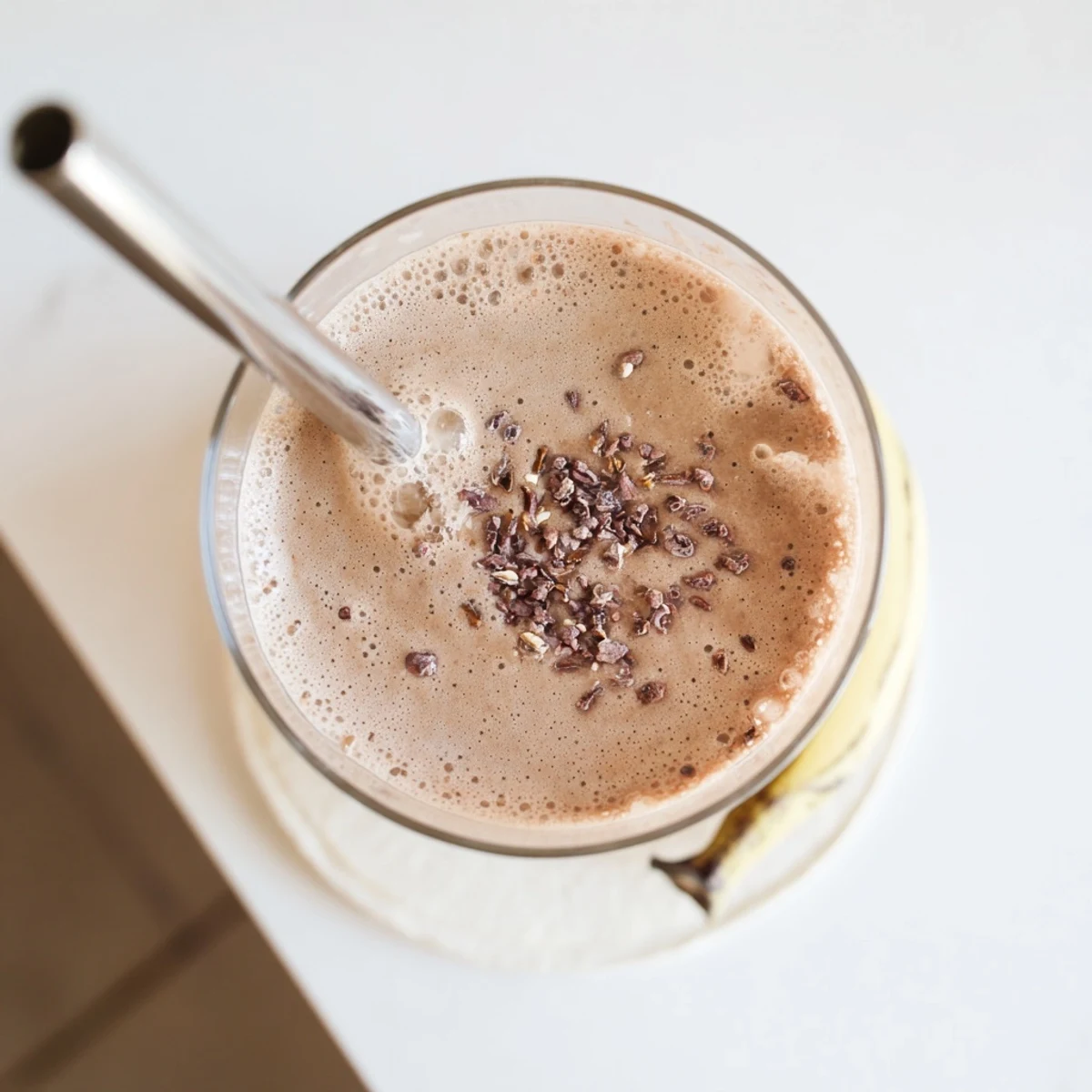 Creamy raw chocolate banana shake blended with frozen bananas and plant-based milk