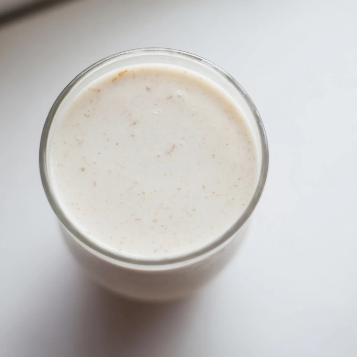 Fresh almond milk in a clear pitcher showing the smooth dairy-free beverage ready for drinking