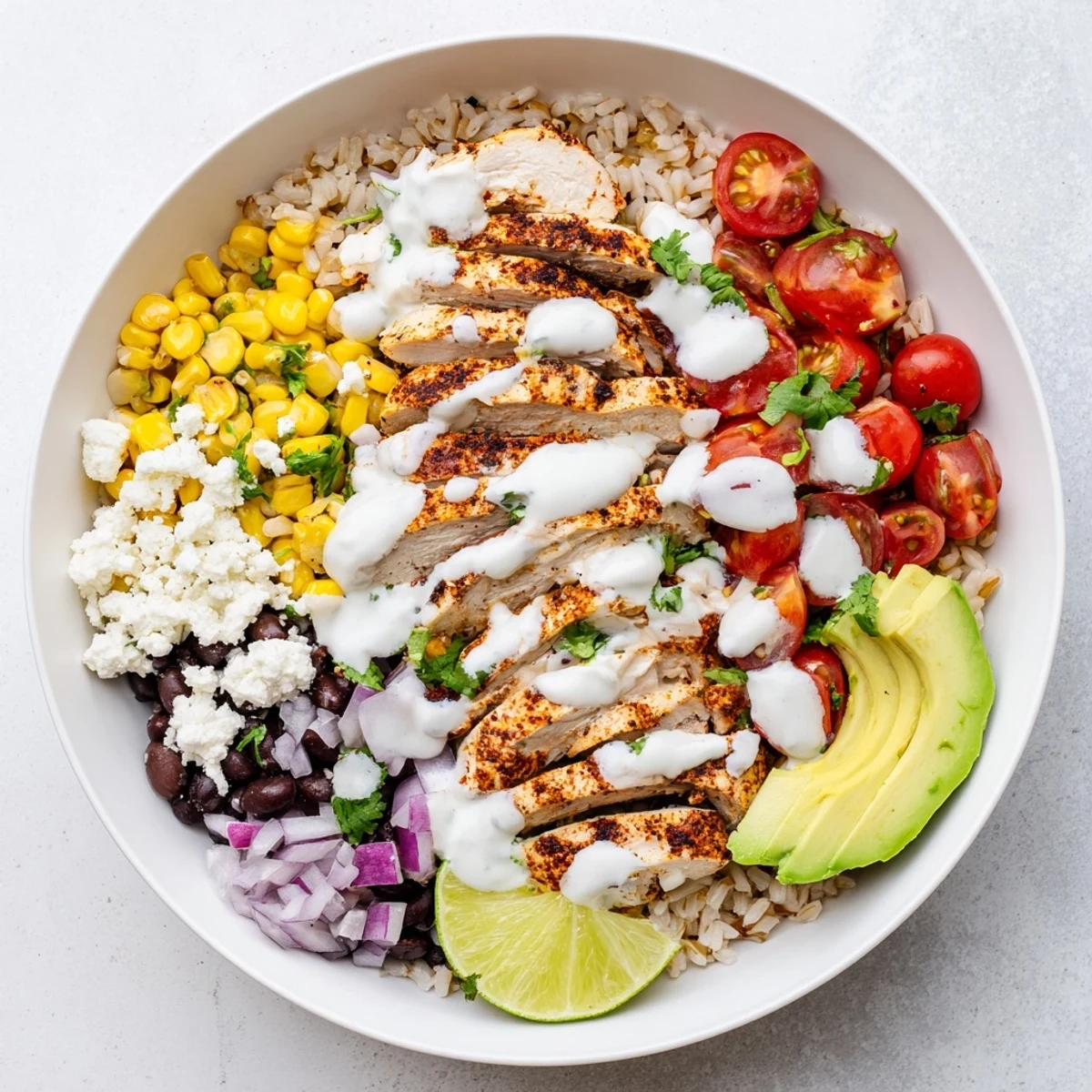 Grilled chicken street corn bowl topped with fresh tomatoes and cilantro