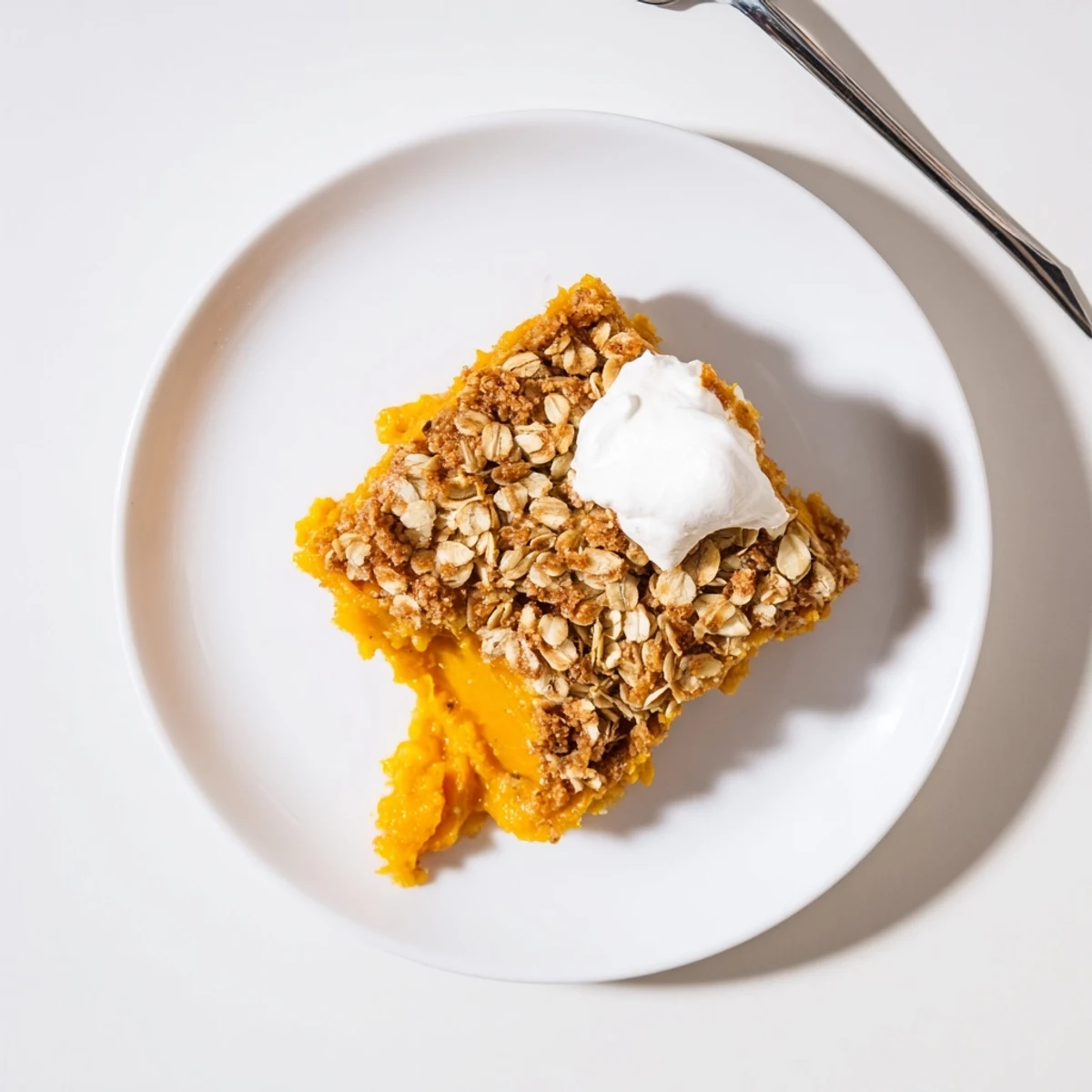 Creamy pumpkin pie crisp with golden oat crumble fresh from the oven