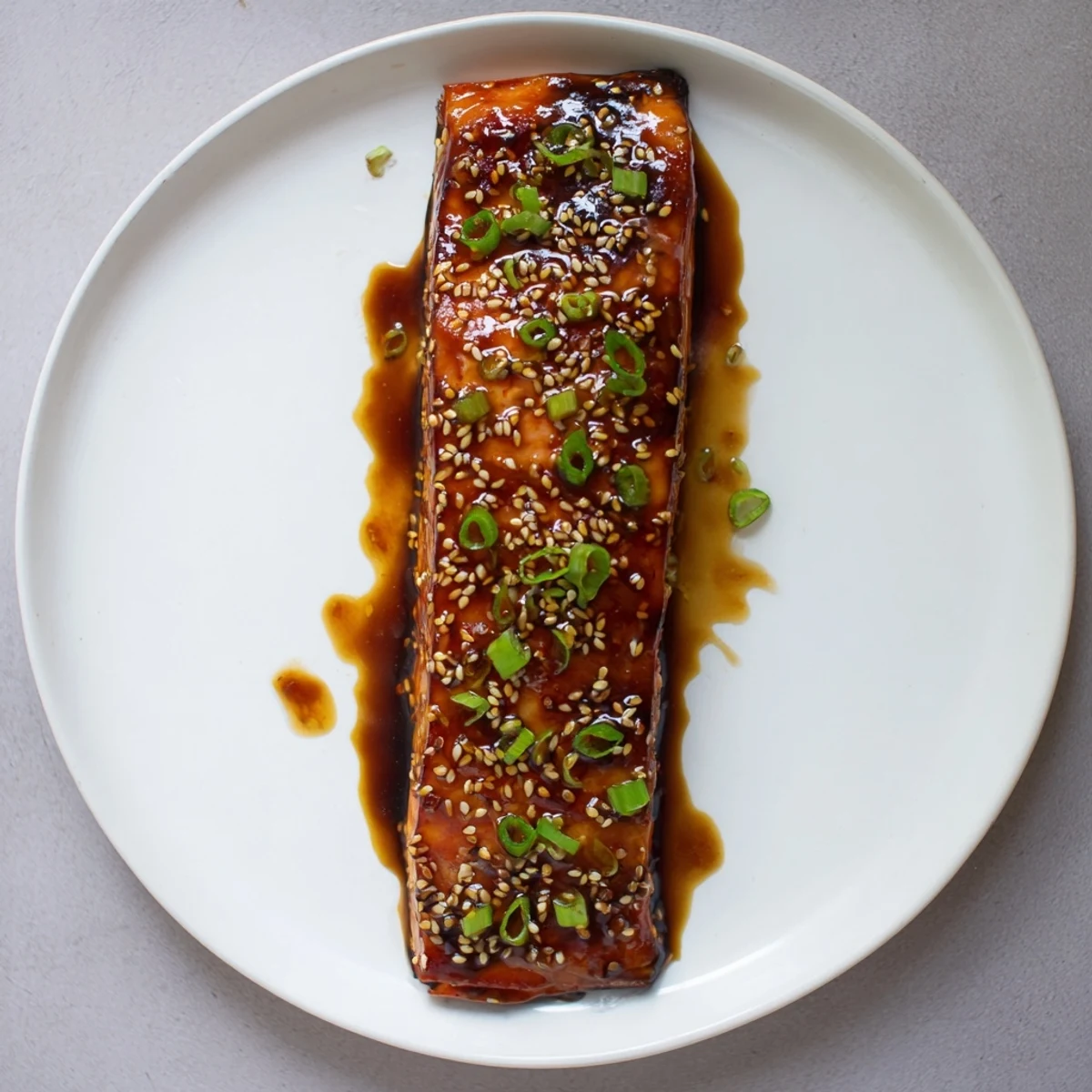 Juicy baked salmon drizzled with gluten free teriyaki sauce and sprinkled with sesame seeds