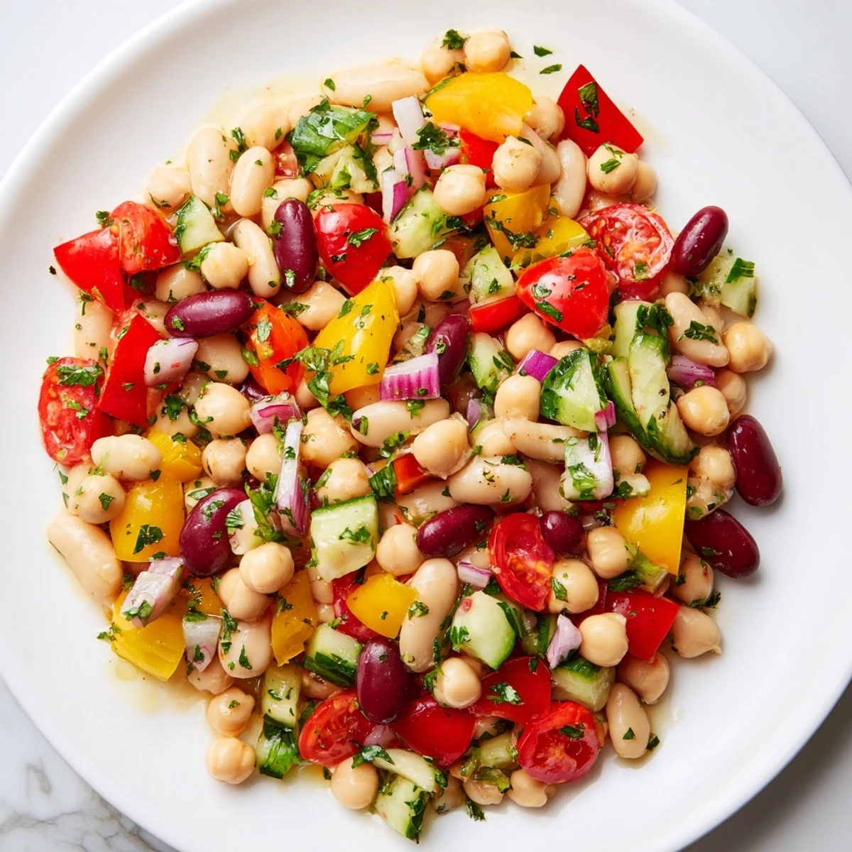 Vibrant Italian bean salad served chilled in a bowl garnished with fresh parsley