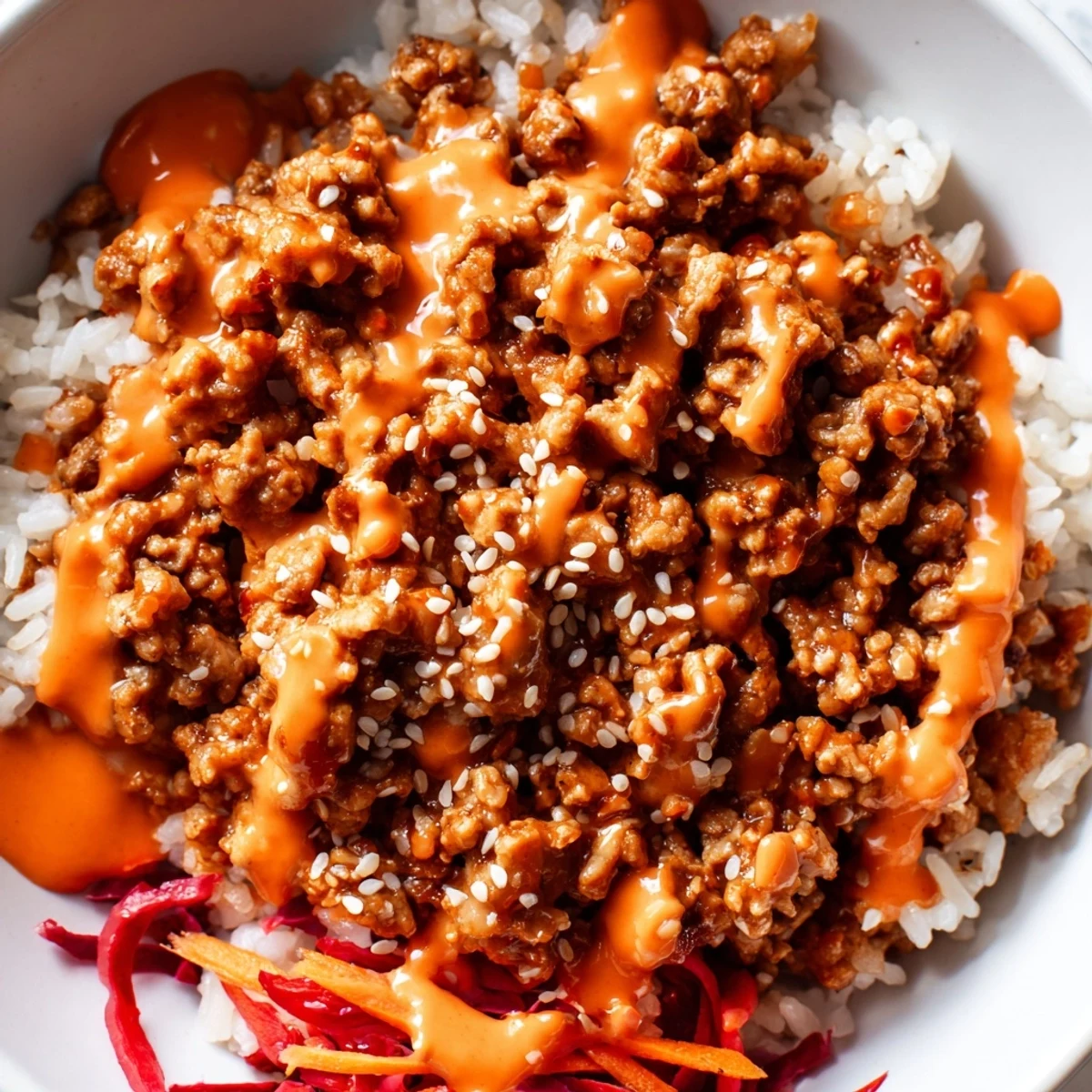 A colorful bowl of Ground Turkey Rice Bowls drizzled with sweet chili Bang Bang sauce