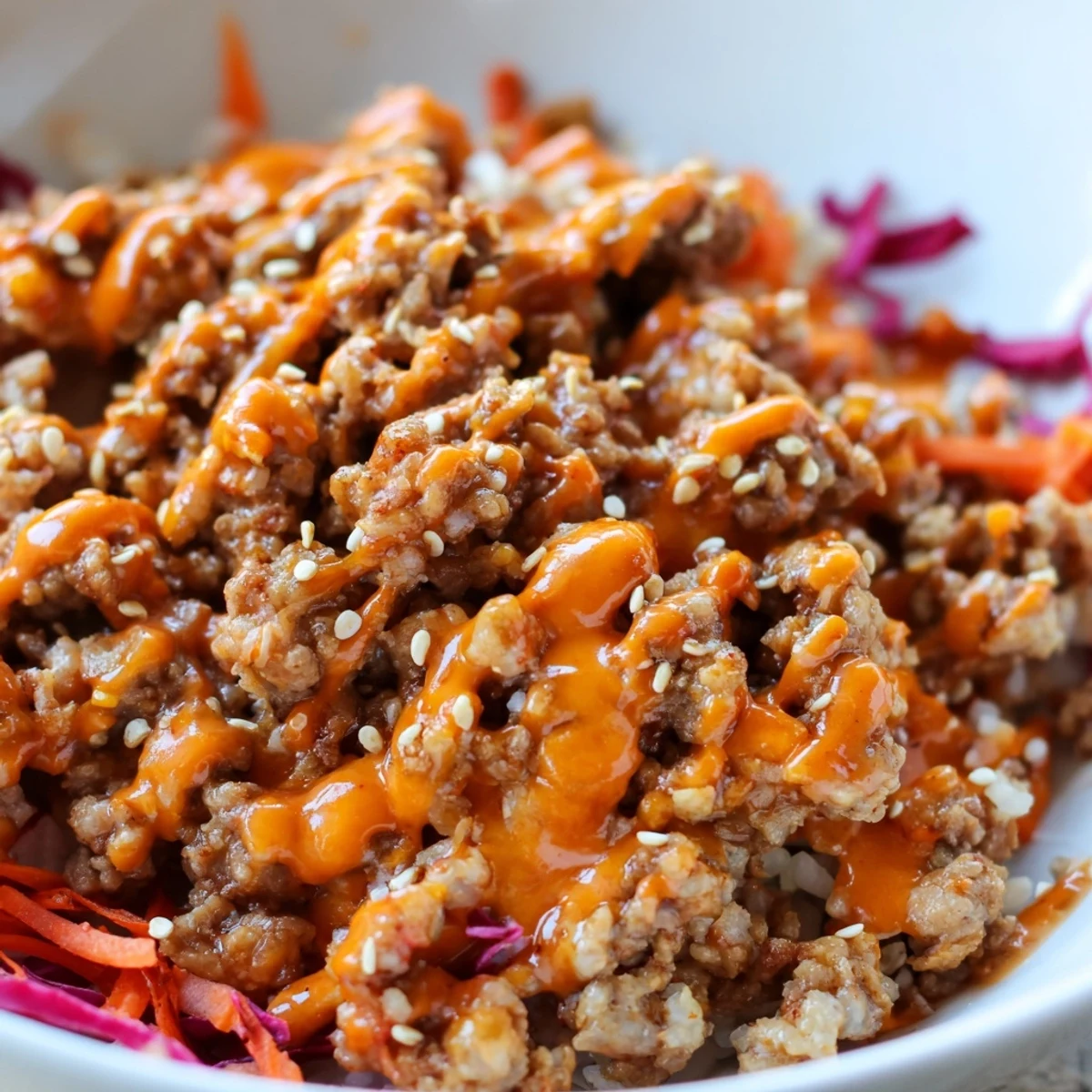 Ground Turkey Rice Bowls topped with crisp veggies and creamy spicy Bang Bang sauce