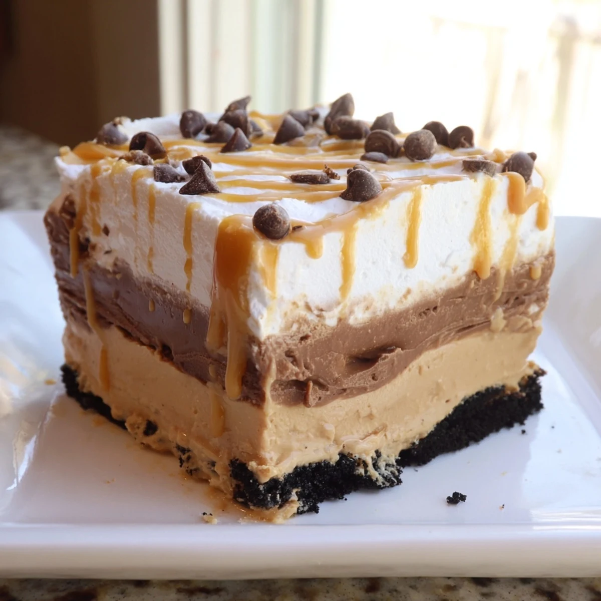 Peanut butter layered delight sliced into neat squares with chocolate drizzle on top