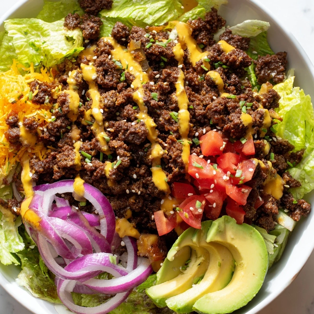 Colorful burger bowls with seasoned beef, melted cheddar, and fresh avocado slices
