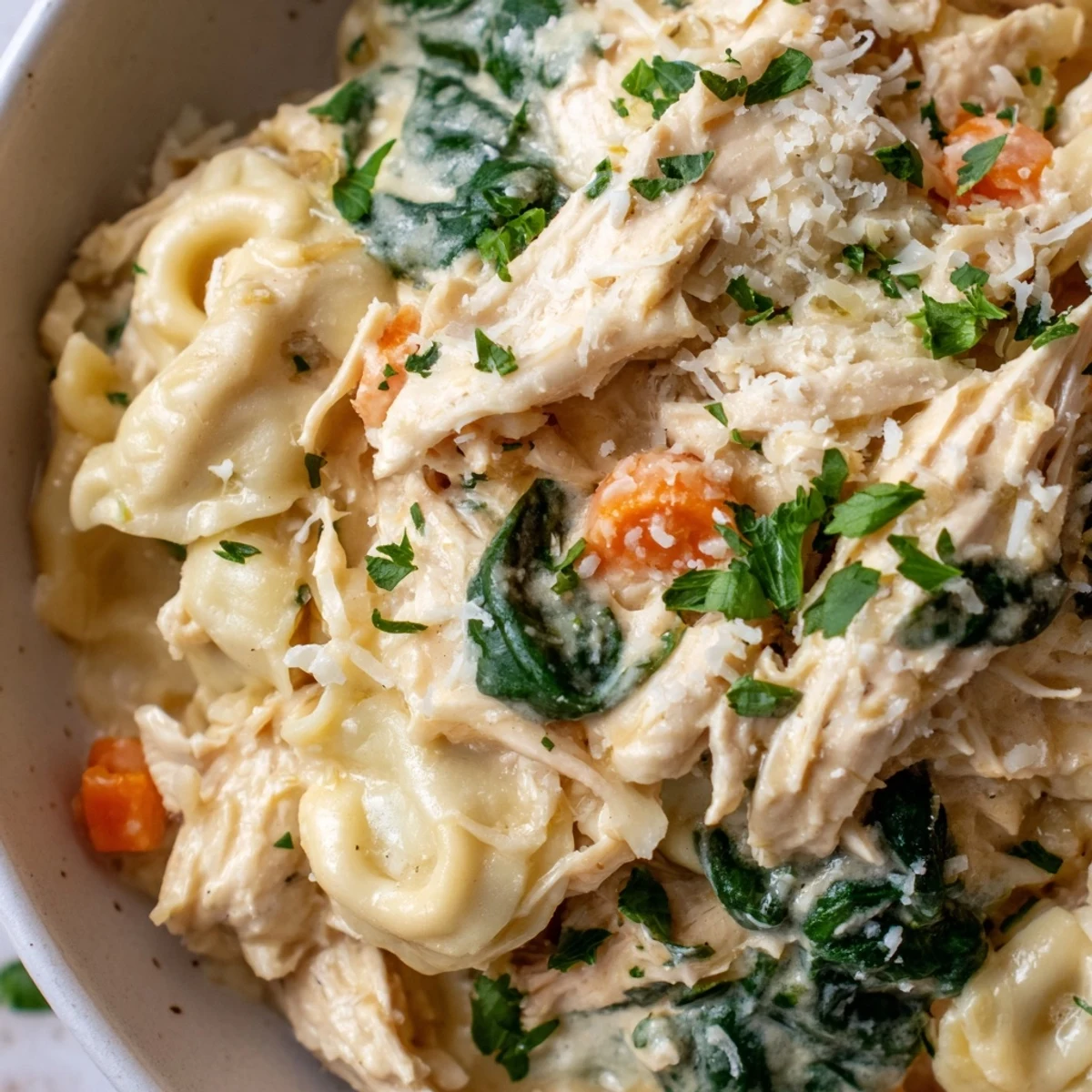 Creamy crockpot chicken tortellini with tender shredded chicken and vibrant vegetables