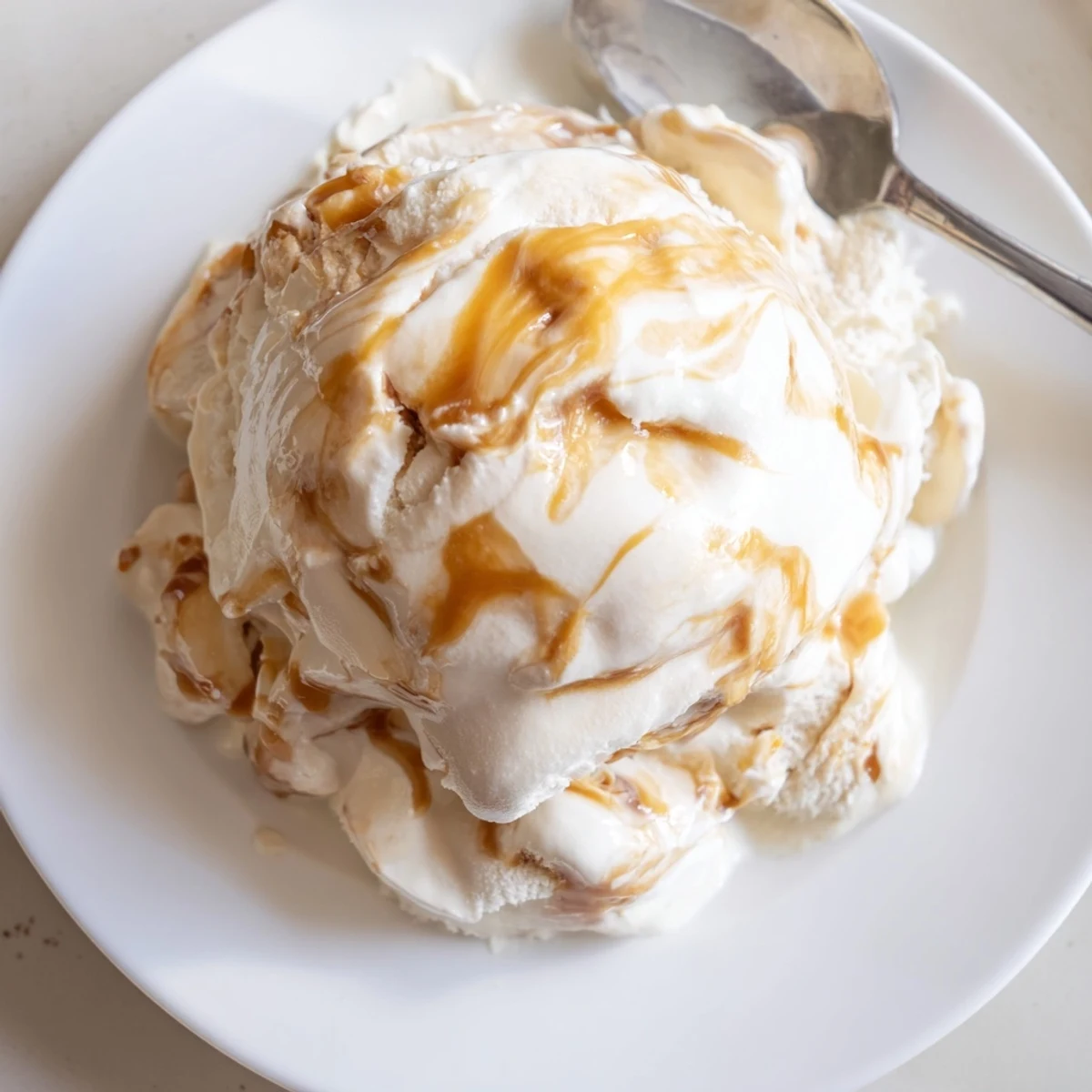 Rich scoops of no churn salted caramel ice cream swirled with golden sauce.  