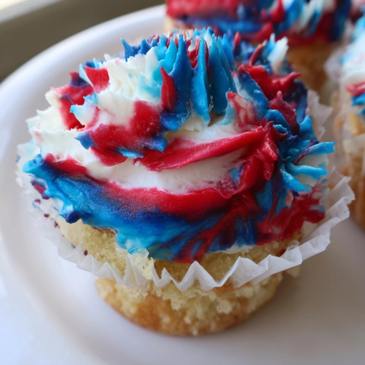 Colorful July tie dye cupcakes perfect for Independence Day celebrations.