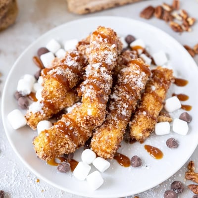 A close-up of the Salted Caramel Apple Fries Board showing crunchy panko-coated apples and sweet dipping toppings.